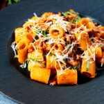 Spicy chicken mince pasta with fresh basil and parmesan cheese.