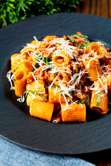 Spicy chicken mince pasta with fresh basil and parmesan cheese.