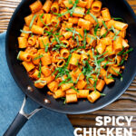 Overhead spicy ground chicken rigatoni with fresh basil in a pan featuring a title overlay.
