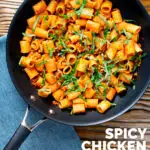 Overhead spicy ground chicken rigatoni with fresh basil in a pan featuring a title overlay.