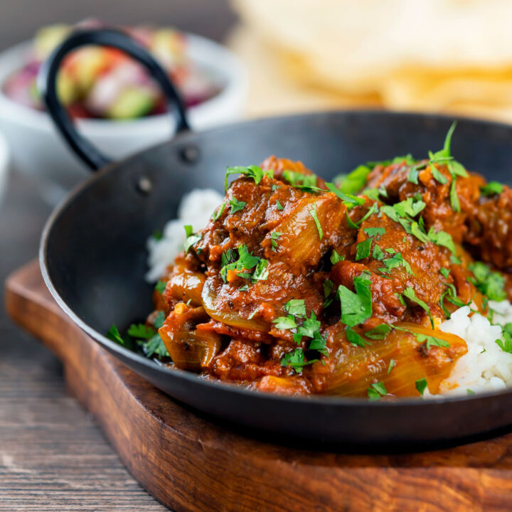 Spicy beef bhuna curry or bhuna gosht served with rice.