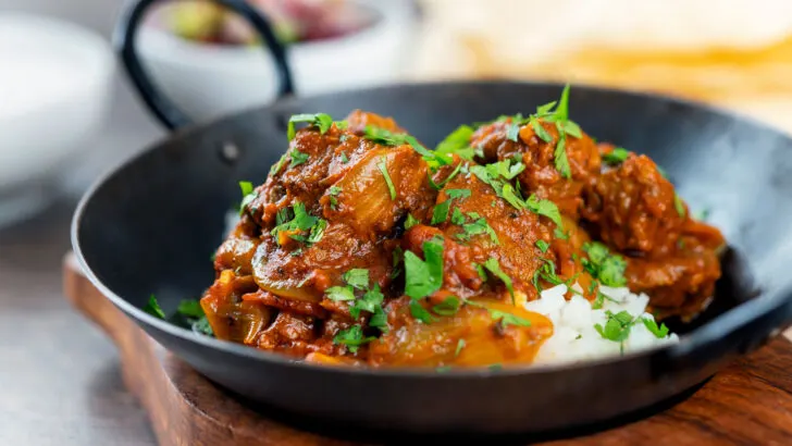 Spicy beef bhuna curry or bhuna gosht served with rice.