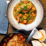 Overhead old fashioned braised rabbit leg stew with pearl barley.