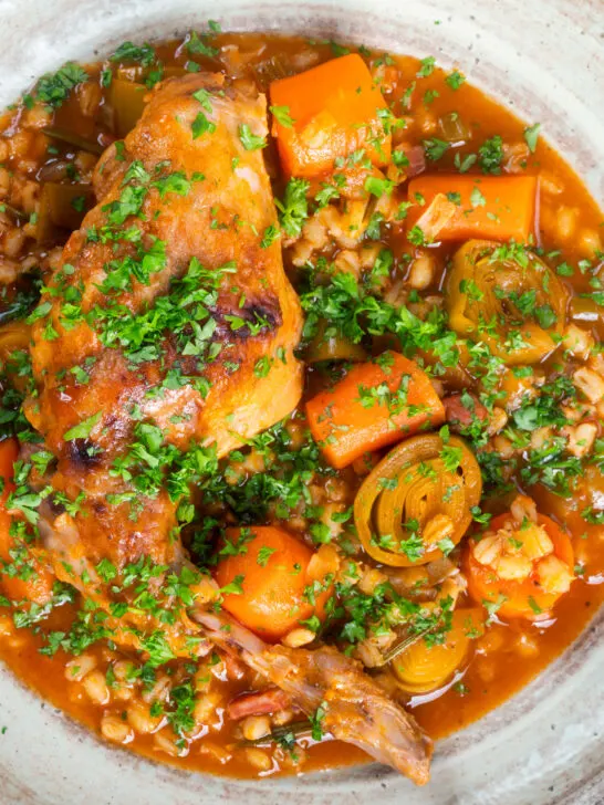 Close-up stewed rabbit with pearl barley, leeks and carrots.