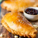 Homemade cheese and onion pasty with Branston pickle in shortcrust pastry.