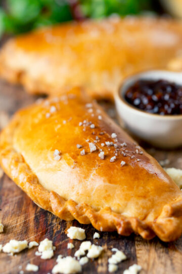 Homemade cheese and onion pasty with Branston pickle in shortcrust pastry.