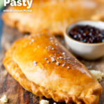 Homemade cheese and onion pasty with Branston pickle in shortcrust pastry featuring a title overlay.