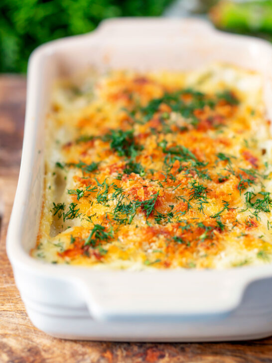 Golden cheesy smoked haddock and potato gratin with spinach and fresh dill.