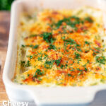 Golden cheesy smoked haddock and potato gratin with spinach and fresh dill featuring a title overlay.