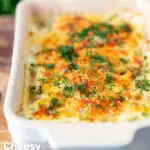 Golden cheesy smoked haddock and potato gratin with spinach and fresh dill featuring a title overlay.