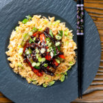 Overhead Chinese takeaway style sticky crispy chilli beef in a sticky sauce.