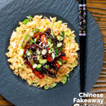 Overhead Chinese takeaway style sticky crispy chilli beef in a sticky sauce featuring a title overlay.