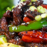 Chinese takeaway style sticky crispy chilli beef with peppers and egg fried rice.