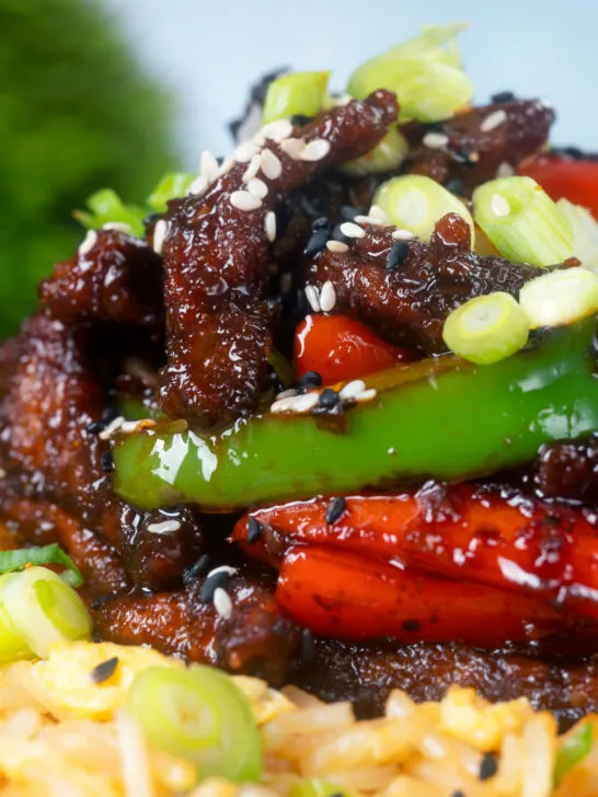 Chinese takeaway style sticky crispy chilli beef with peppers and egg fried rice.