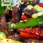 Chinese takeaway style sticky crispy chilli beef with peppers and egg fried rice featuring a title overlay.