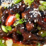 Close-up Chinese takeaway style sticky crispy chilli beef in a sticky sauce featuring a title overlay.