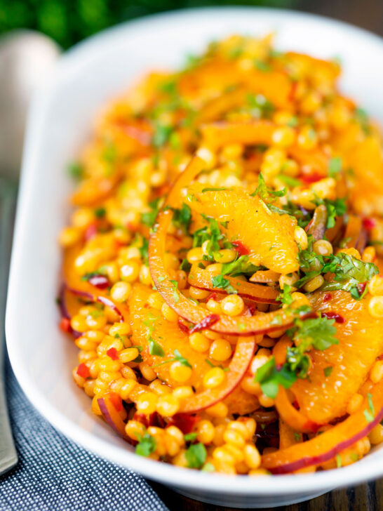 Giant couscous salad with rose harissa paste and oranges.