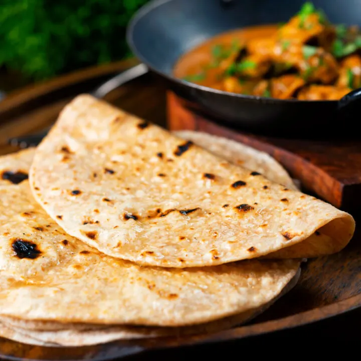 Homemade Indian chapati flatbread brushed with ghee and served with a curry.