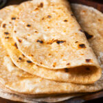 Close-up homemade Indian chapati flatbread that have been brushed with ghee.
