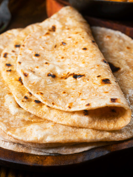 Close-up homemade Indian chapati flatbread that have been brushed with ghee.