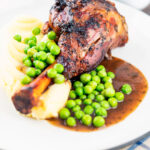 Oven cooked minted lamb shanks served with peas, mashed potato and red wine gravy.