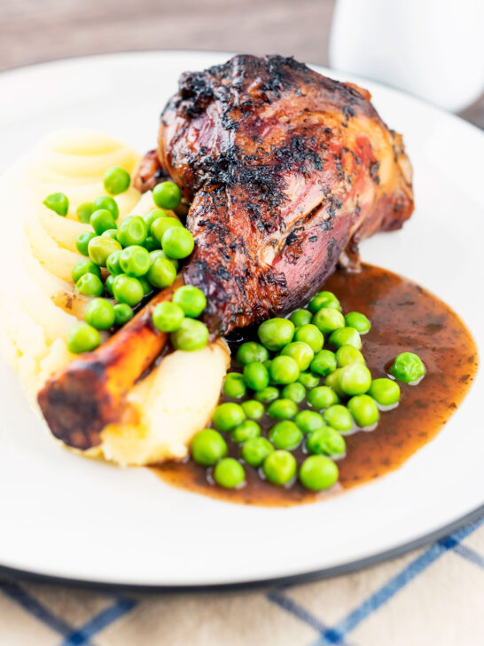 Oven cooked minted lamb shanks served with peas, mashed potato and red wine gravy.