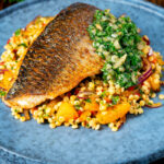 Pan fried grey mullet fillet served with preserved lemons and parsley and giant couscous.