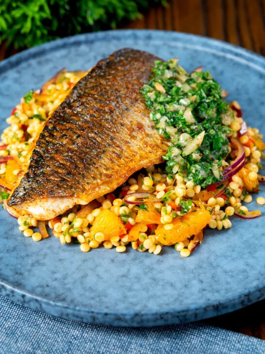 Pan fried grey mullet fillet served with preserved lemons and parsley and giant couscous.