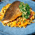 Pan fried grey mullet fillet served with preserved lemons and parsley and giant couscous featuring a title overlay.