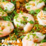 Close-up prawn and chorizo paella served in a paella pan with lemon and parsley featuring a title overlay.
