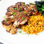Oven roasted and glazed cauliflower steak served with giant couscous salad.
