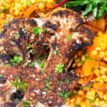 Overhead close-up oven roasted cauliflower steak served with giant couscous salad.