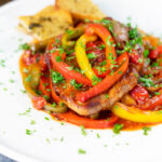Slow cooker pork chops with peppers, tomatoes and Worcestershire sauce.