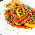 Slow cooker pork chops with peppers, tomatoes and Worcestershire sauce featuring a title overlay.