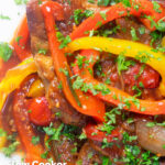 Close up Crock Pot pork chops with peppers, tomatoes and Worcestershire sauce featuring a title overlay.