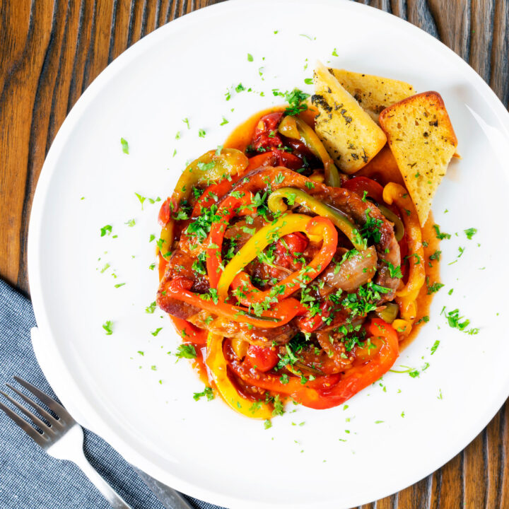 Slow cooker pork chops with garlic, peppers and tomatoes.