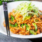 Dan dan noodles, a spicy pork mince stir fry with peanuts and chilli with spring onions featuring a title overlay.