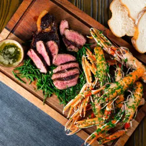 Surf and turf sharing board with Langoustine, samphire, garlic butter and samphire.
