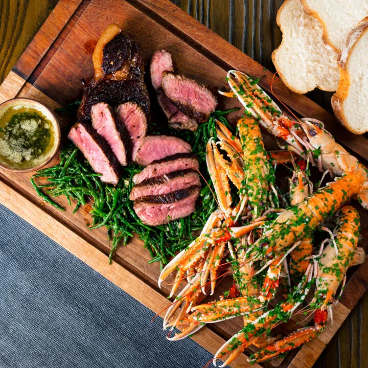 Surf and turf sharing board with Langoustine, samphire, garlic butter and samphire.