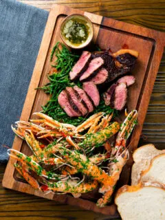 Overhead surf and turf sharing board with langoustine, steak and samphire.