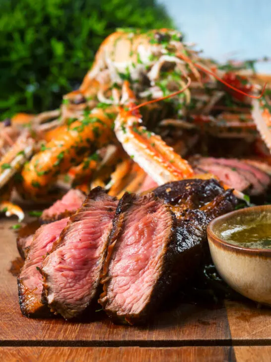 Close-up image of steak cooked pink as part of a surf and turf dinner.