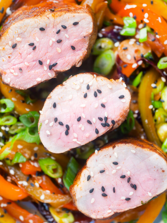 Overhead close-up roasted sweet and sour pork tenderloin with mixed peppers.