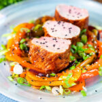 Sweet and sour pork tenderloin roast with mixed peppers.