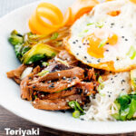 Wagamama inspired shredded teriyaki duck donburi rice dish with a fried egg featuring a title overlay.