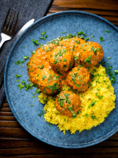 Overhead venison meatballs in an Indian-style yoghurt-based curry sauce with pilau rice.