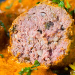 Cut open venison meatball in an Indian-style yoghurt-based curry sauce.