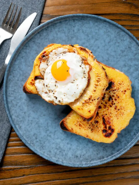 Overhead Welsh rarebit or British cheese on toast with a fried egg.