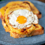 Welsh rarebit or British cheese on toast with a fried egg.