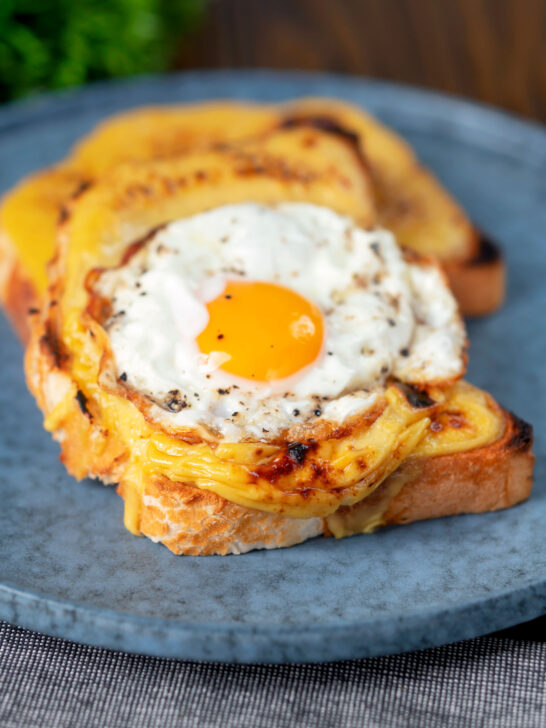 Welsh rarebit or British cheese on toast with a fried egg.