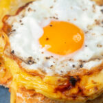 Fried egg served on top of Welsh rarebit or British cheese on toast aka buck rarebit.